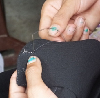 伝統衣装を縫う手